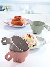 Load image into Gallery viewer, Pink and gray kitchen tool on a white surface with food items in the background