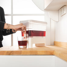 تحميل الصورة في عارض المعرض، 1 Pcs Beverage Dispenser with Dual-Use Stand - Plastic Food Container For Detox and Juice 4.5 Liters being used to serve a drink.