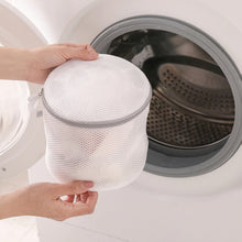 Load image into Gallery viewer, Cylindrical mesh laundry bag beside a washing machine