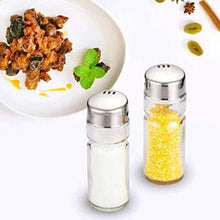 تحميل الصورة في عارض المعرض، Two salt shakers with a plate of food in the background