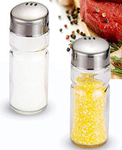 Load image into Gallery viewer, Two glass salt and pepper shakers with metal tops on a white background.
