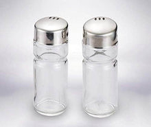 تحميل الصورة في عارض المعرض، Two clear glass salt and pepper shakers with silver lids on a light gray background