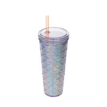 Load image into Gallery viewer, A clear plastic tumbler with a mermaid scale pattern that reflects iridescent blue, purple, and gold hues, featuring a clear lid and a translucent peach-colored straw, set against a plain white background.