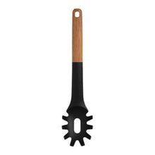Load image into Gallery viewer, Black pasta server with a wooden handle on a white background