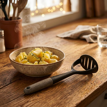 تحميل الصورة في عارض المعرض، A black plastic potato masher with a wooden handle.