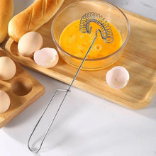 Load image into Gallery viewer, Glass bowl with whisked eggs, eggs, and a loaf of bread on a wooden board.
