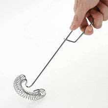 Load image into Gallery viewer, Metal whisk held by a hand on a white background