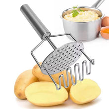 Load image into Gallery viewer, A stainless steel potato masher with a double press mechanism, alongside raw potatoes and a small bowl of mashed potatoes.