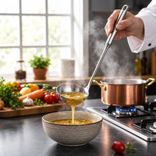 Load image into Gallery viewer, A stainless steel soup ladle with a long handle, displayed on a dark surface with vegetables in the background.