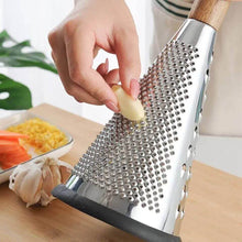 Load image into Gallery viewer, Hand grating garlic on a cone grater