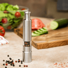 Load image into Gallery viewer, Stainless steel pepper and spice grinder with adjustable coarseness, ideal for seasoning dishes in the kitchen.