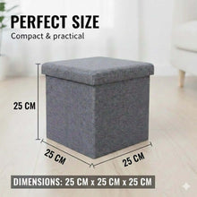 تحميل الصورة في عارض المعرض، Gray storage ottoman with dimensions labeled on a light wooden floor.