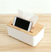 Load image into Gallery viewer, A white plastic tissue box holder with a wooden cover, positioned on a wooden surface, with a mobile phone resting on top of the tissue box.