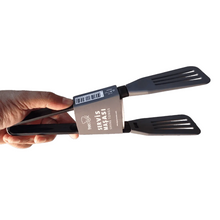 Load image into Gallery viewer, Hand holding packaged slotted serving tongs