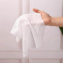 Load image into Gallery viewer, Hand holding a white textured towel against a light background
