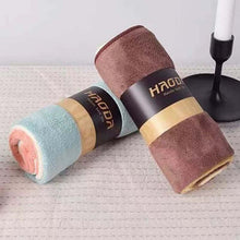 Load image into Gallery viewer, Three rolled-up towels with 'HAGDA' branding on a textured surface.
