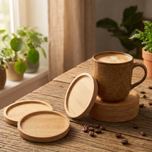 Load image into Gallery viewer, Round bamboo coasters with a coffee mug on a wooden table