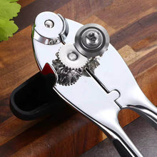 Load image into Gallery viewer, Heavy-duty stainless steel can opener with sharp cutting wheels and ergonomic non-slip handle on a wooden surface.