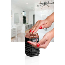 Load image into Gallery viewer, Hand pressing the copper pump of the black Luna dispenser