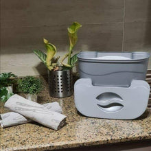 Load image into Gallery viewer, White laundry basket on a countertop next to a washing machine with plants in the background.