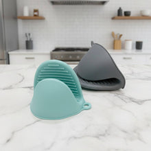 Load image into Gallery viewer, Mini Silicone Oven Mitts Pot Holders - 2 Pcs Premium Silicone Tray Grabber in blue and gray on a kitchen counter.