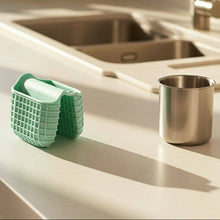 Load image into Gallery viewer, Mini Silicone Oven Mitts Pot Holders - 1 Pc Premium Silicone Tray Grabber on a kitchen countertop with a metal cup.