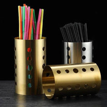 تحميل الصورة في عارض المعرض، Stainless steel and gold round cutlery holder for organizing utensils with vibrant straws and black stirrers.