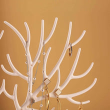 Load image into Gallery viewer, Elegant deer-shaped jewelry organizer displaying necklaces and earrings against a warm background.