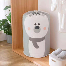 Load image into Gallery viewer, A large quilt and clothes storage bag with a cartoon bear face design, placed on the floor against a wooden background, with a rope design at the top.