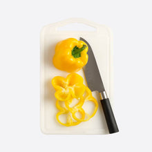 تحميل الصورة في عارض المعرض، Yellow bell pepper rings and a knife on a cutting board with a white background