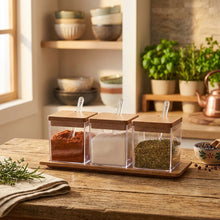 تحميل الصورة في عارض المعرض، Set of glass spice containers with wooden lids on a white surface