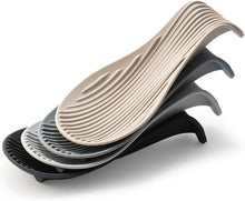 Load image into Gallery viewer, Stack of wavy silicone mats in beige, gray, and black on a white background
