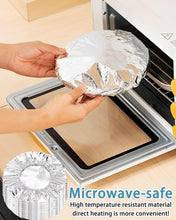 Load image into Gallery viewer, Person placing reusable aluminum foil cover in microwave, showcasing its microwave-safe and heat-resistant features.
