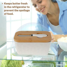 Load image into Gallery viewer, Porcelain butter dish with bamboo lid and spreader, keeping butter fresh in refrigerator to prevent spoilage.
