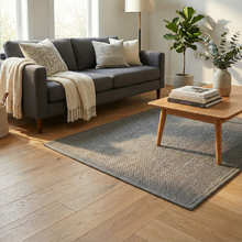 تحميل الصورة في عارض المعرض، Living room with a gray sofa, wooden coffee table, and decorative items.
