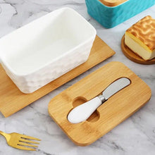 Load image into Gallery viewer, Porcelain butter dish with bamboo lid and spreader on wooden board, perfect for storing butter.
