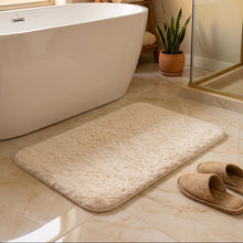 Load image into Gallery viewer, Off-white shaggy bath mat beside a bathtub and slippers
