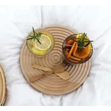 Load image into Gallery viewer, Round woven placemat with glasses of lemonade and oranges on a white surface
