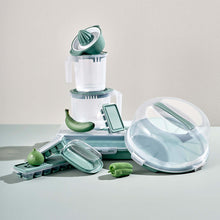 تحميل الصورة في عارض المعرض، Set of kitchen tools including a juicer, containers, and a peeler on a light surface.
