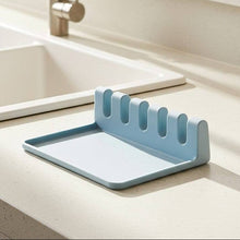 Load image into Gallery viewer, Blue dish drying rack on a kitchen counter next to a sink.
