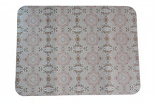 Load image into Gallery viewer, A rectangular desk mat with rounded corners featuring a repeating ornate damask pattern in dusty pink and brown on a light beige background, resting on a wooden desk.

