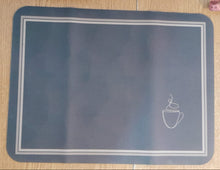 تحميل الصورة في عارض المعرض، A dark slate blue rectangular mouse pad with rounded corners, featuring a thin white double-line border and a small white line-art lamp icon near the top right, shown on a light wood desk.
