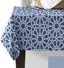 Load image into Gallery viewer, Blue geometric patterned tablecloth on a table with a white background
