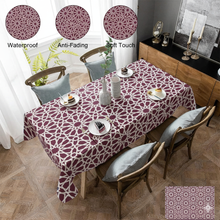 Load image into Gallery viewer, Dining table with a patterned tablecloth, surrounded by chairs and decor items.
