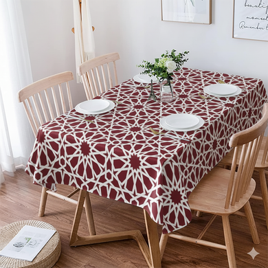 Dining table with a red and white patterned tablecloth, surrounded by wooden chairs.