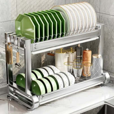 Dish rack with plates, bowls, and glasses on a kitchen counter.