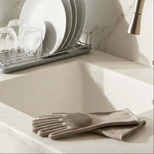 Load image into Gallery viewer, Dishwashing gloves on a kitchen counter with a sink and dish rack in the background.
