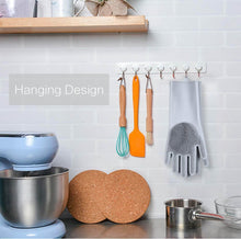 Load image into Gallery viewer, Kitchen utensils and tools hanging on a magnetic strip against a tiled wall.

