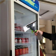 Load image into Gallery viewer, Person using a handheld cleaning device to clean the interior of a refrigerator.
