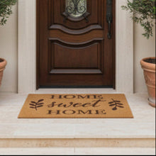 تحميل الصورة في عارض المعرض، Doormat with 'Home sweet Home' text in front of a wooden door.
